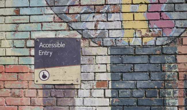 Accessible Entry sign on brick wall