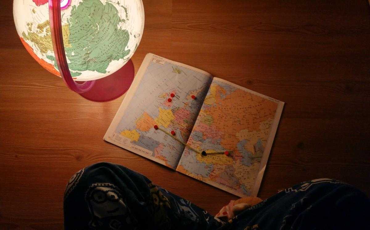 globe and atlas on desk