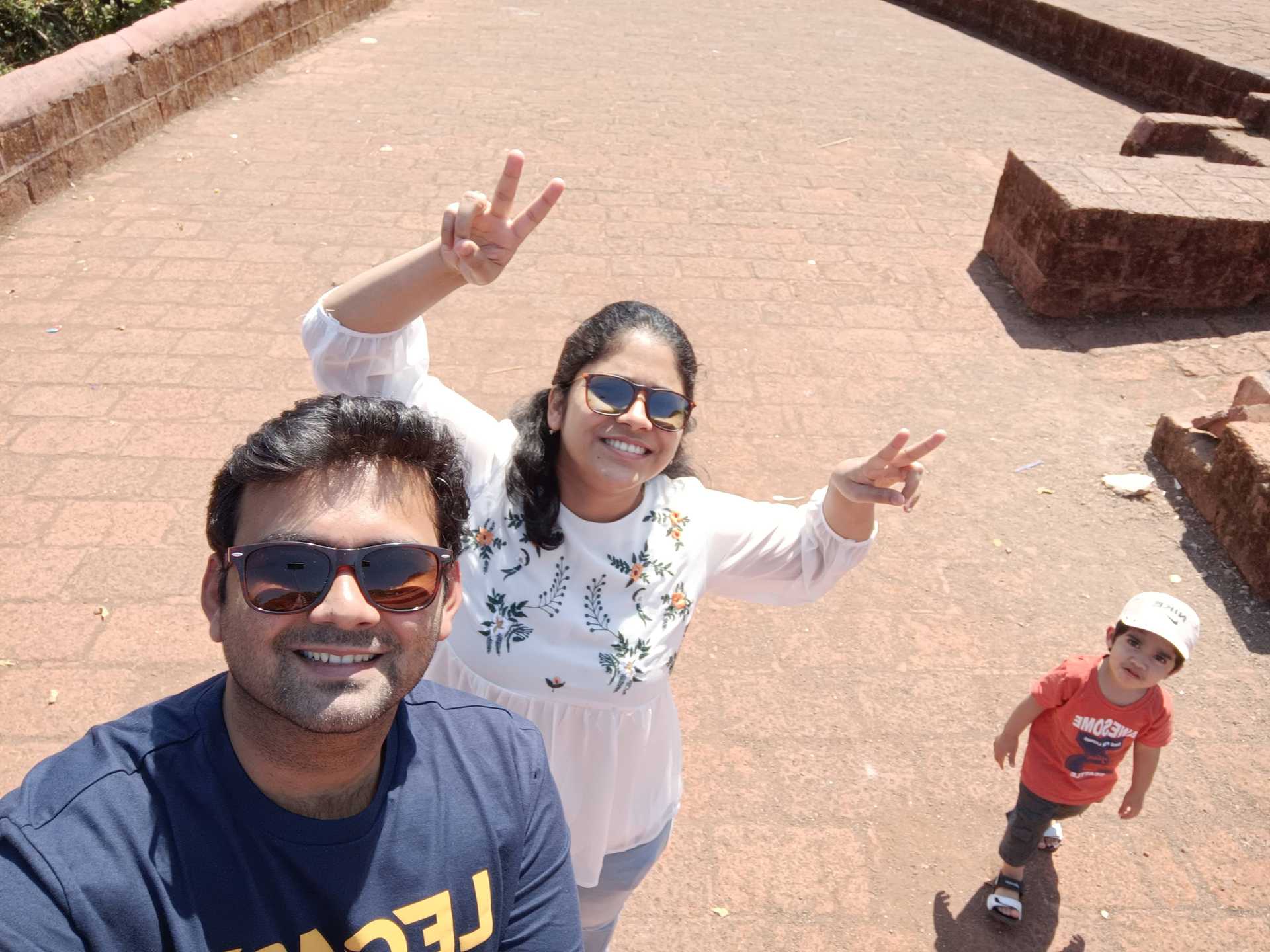 Rishi, Hemangi, and Ayan smiling on a street